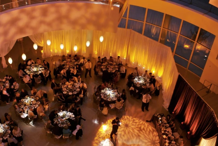 Guests at round dinner tables on the Rotunda floor, seen from the mezzanine