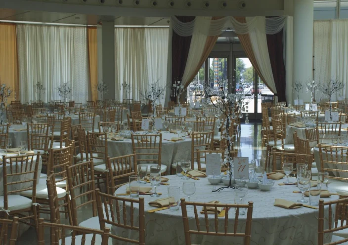 Round tables set with gold chairs inside the Rotunda