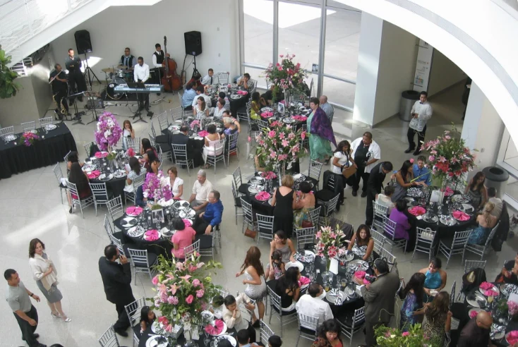 Guests at dinner tables with a live band inside the Rotunda, seen from above