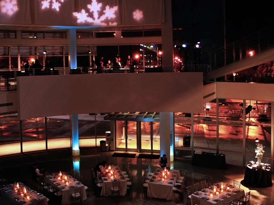 Candlelit dinner tables set inside the Rotunda at night