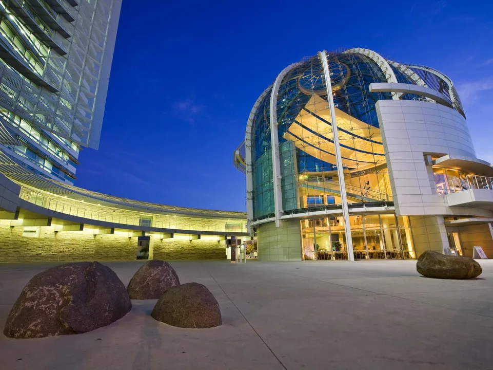 The Rotunda glowing at dusk, seen from the City Hall plaza